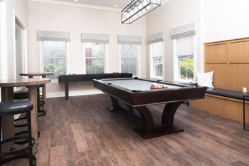 A games room with a pool table and a foosball table